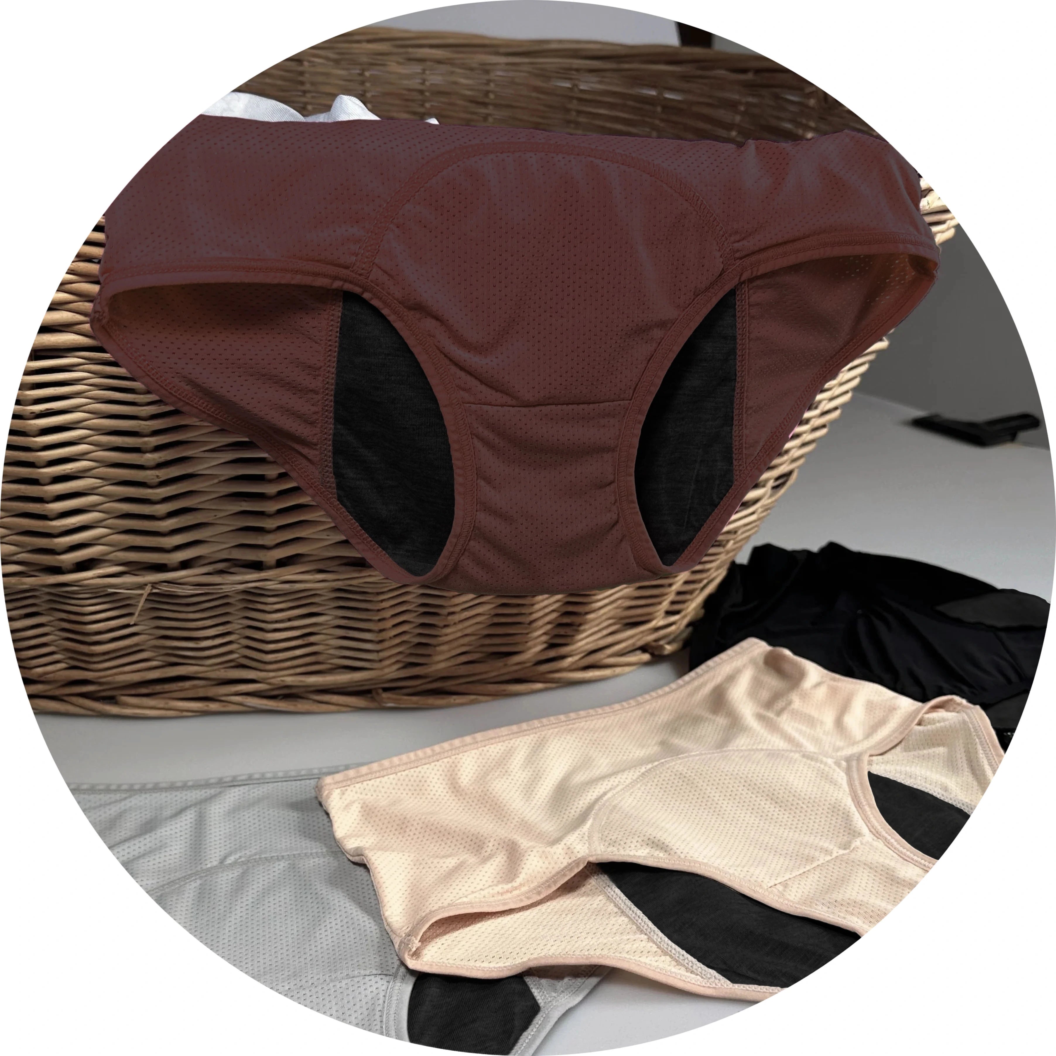 Assorted underwear on a wicker basket and table.